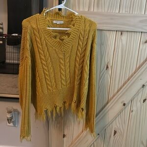 Cable knit sweater with distressed details